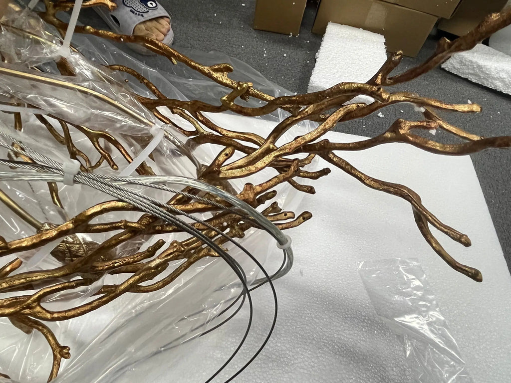 Luxury gold branch crystal chandelier hanging in a modern living room with elegant contemporary décor.