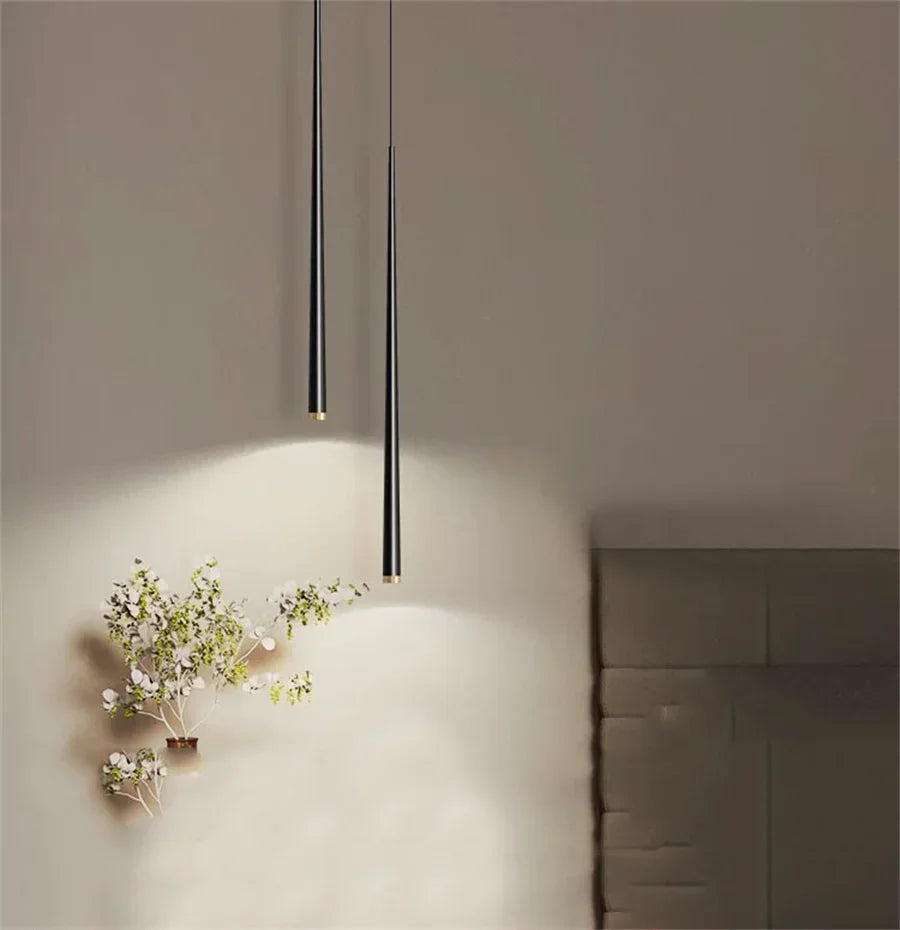 Modern cone LED pendant light hanging above a kitchen island in a contemporary home.