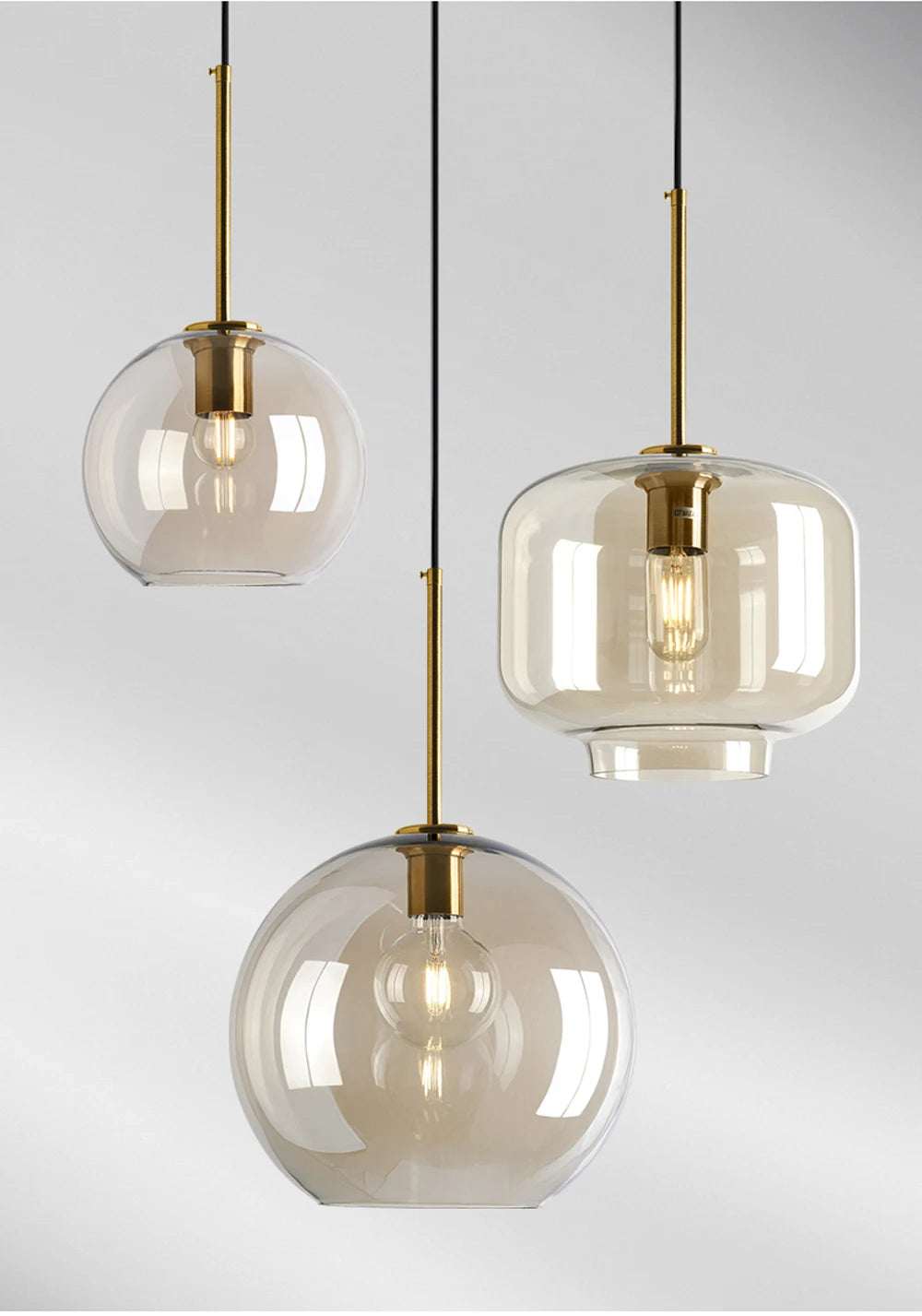 Nordic glass pendant light suspended above a kitchen island in a modern Scandinavian-inspired home.