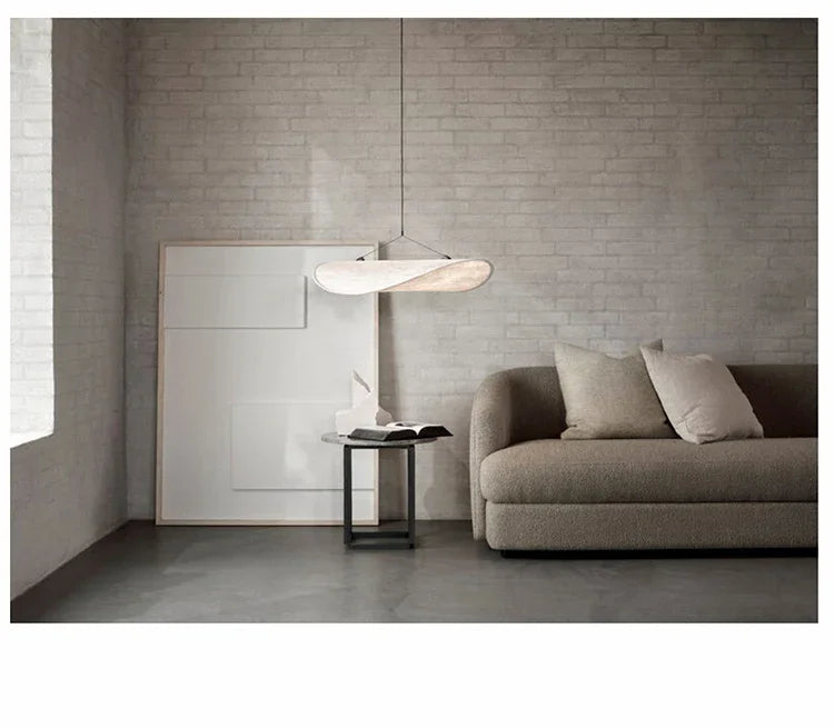 Nordic modern LED pendant light hanging above a dining table in a contemporary living room.