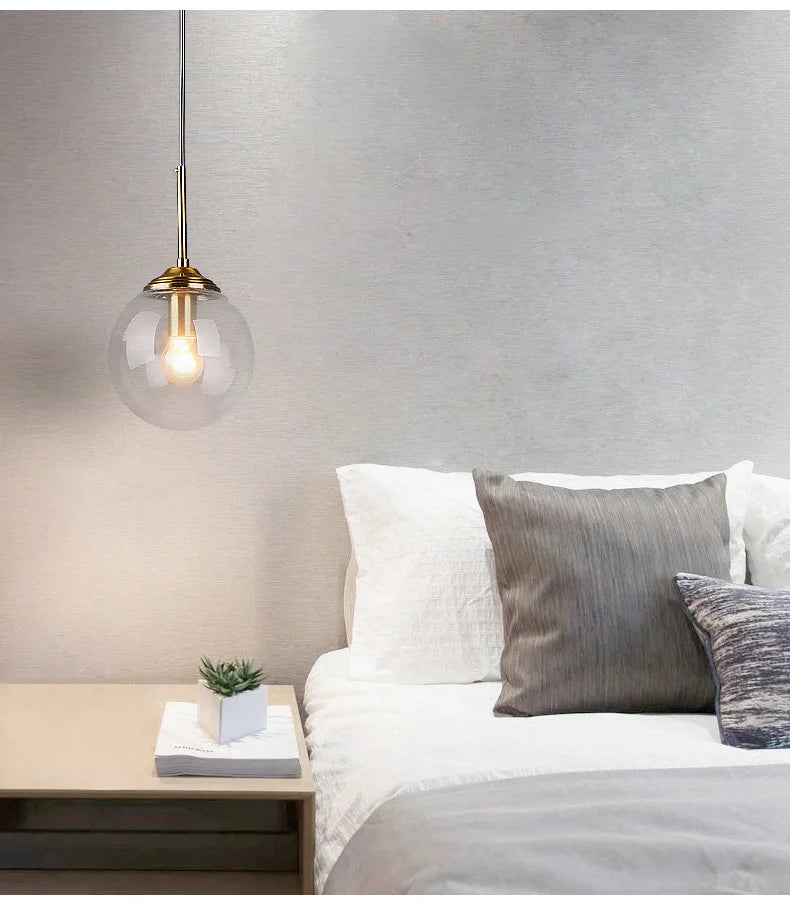 Luxury Nordic glass LED pendant light hanging above a modern dining table in a contemporary home.