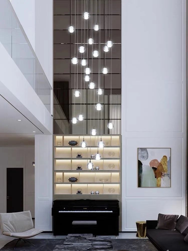 Modern spiral crystal LED chandelier cascading down a luxury staircase in a contemporary home.