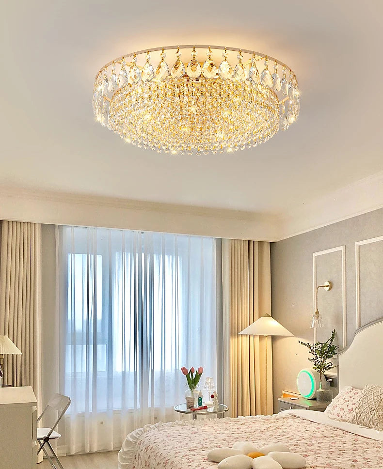 Luxury gold crystal LED chandelier hanging in an elegant modern living room with premium interior décor.