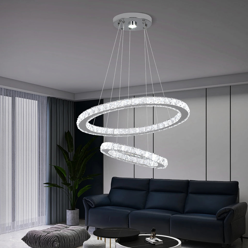 Luxury crystal ring LED chandelier suspended above a modern dining table in an elegant contemporary home.