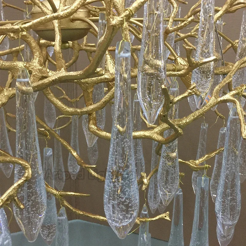 Luxury gold branch crystal chandelier hanging in a modern living room with elegant contemporary décor.