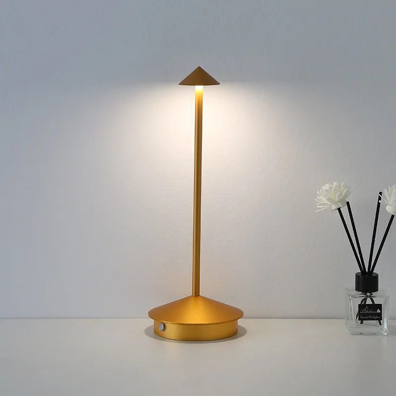 Rechargeable touch LED table lamp placed on a modern dining table in a stylish café-inspired interior.