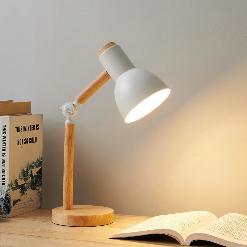Nordic wooden LED table lamp with an adjustable head on a modern bedside table.