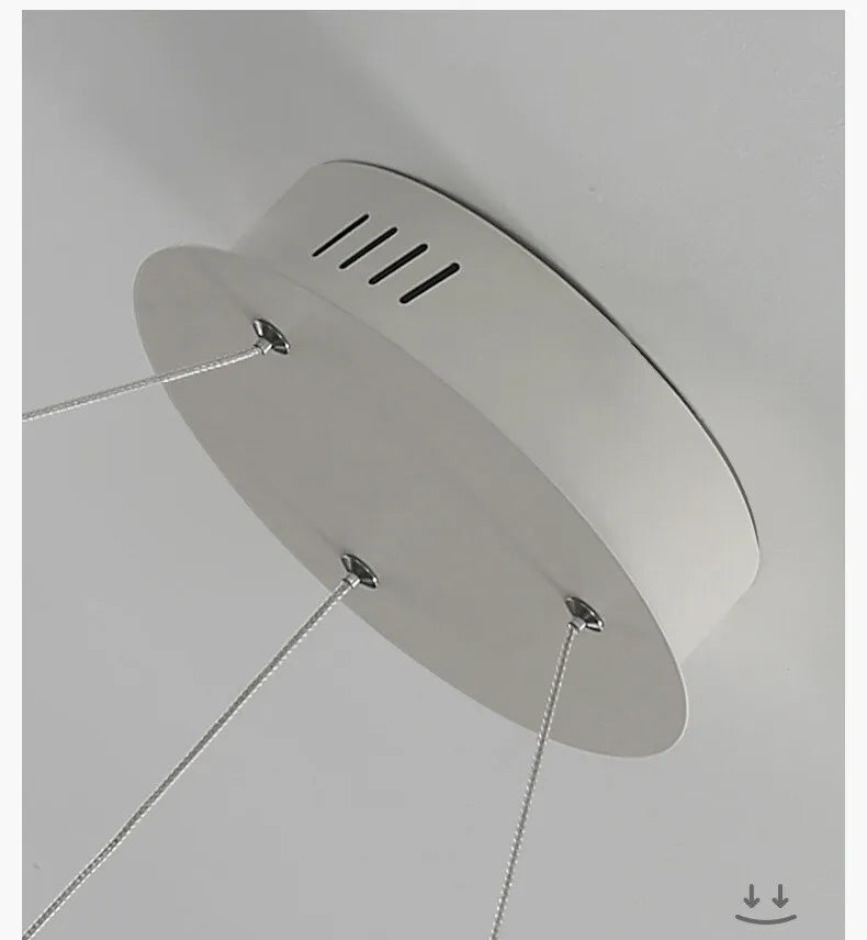 Modern luxe LED ring chandelier suspended in a contemporary living room with elegant minimalist décor.
