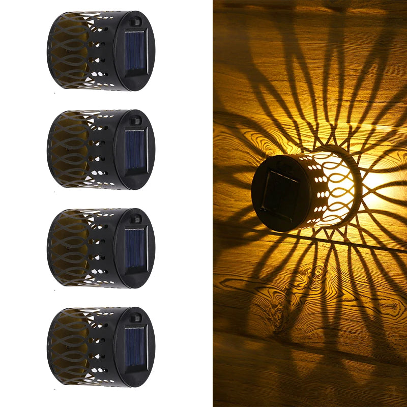 Modern waterproof solar projection LED wall light casting a decorative light pattern on an outdoor garden wall.