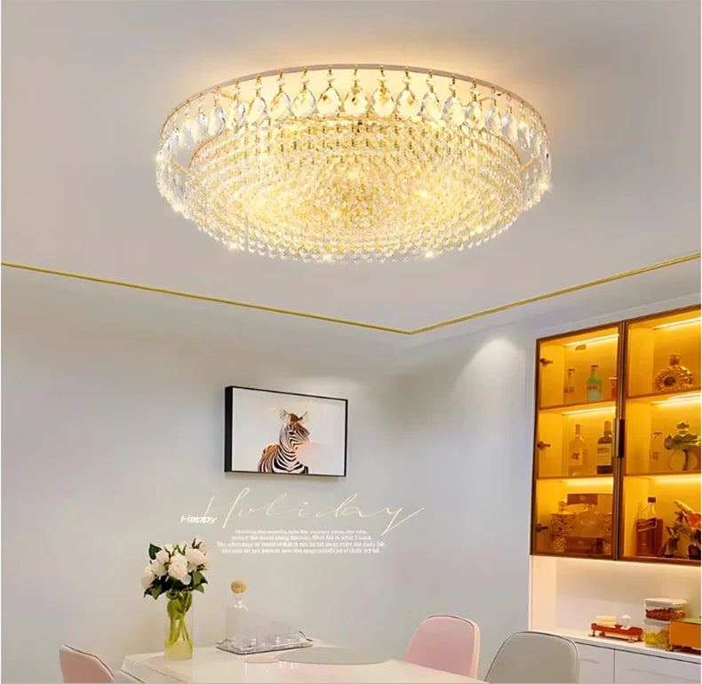 Luxury gold crystal LED chandelier hanging in an elegant modern living room with premium interior décor.