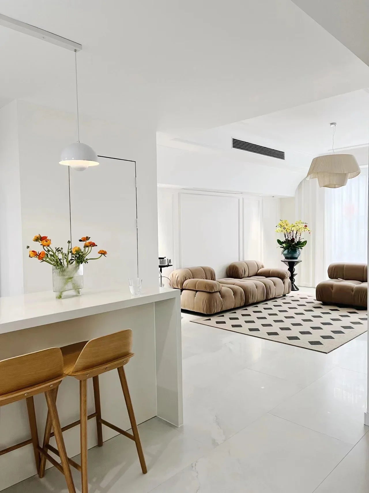 Nordic modern LED pendant light hanging above a dining table in a contemporary living room.