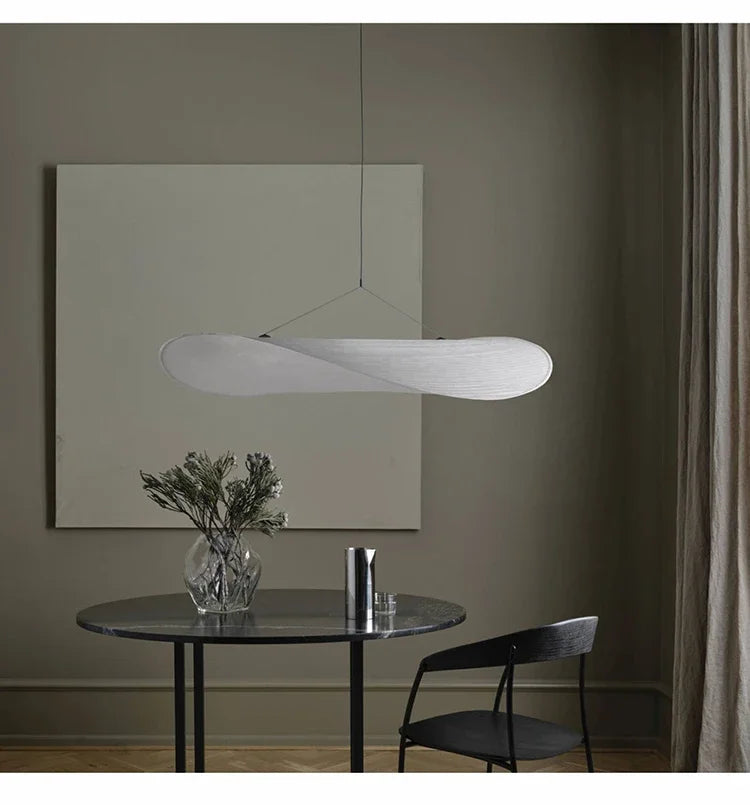 Nordic modern LED pendant light hanging above a dining table in a contemporary living room.