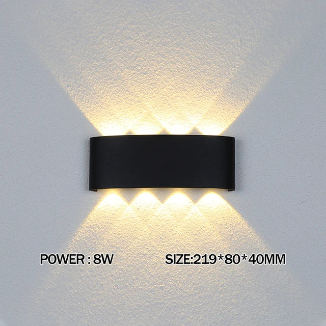 Modern waterproof LED wall light installed on an exterior house wall illuminating a porch and garden.