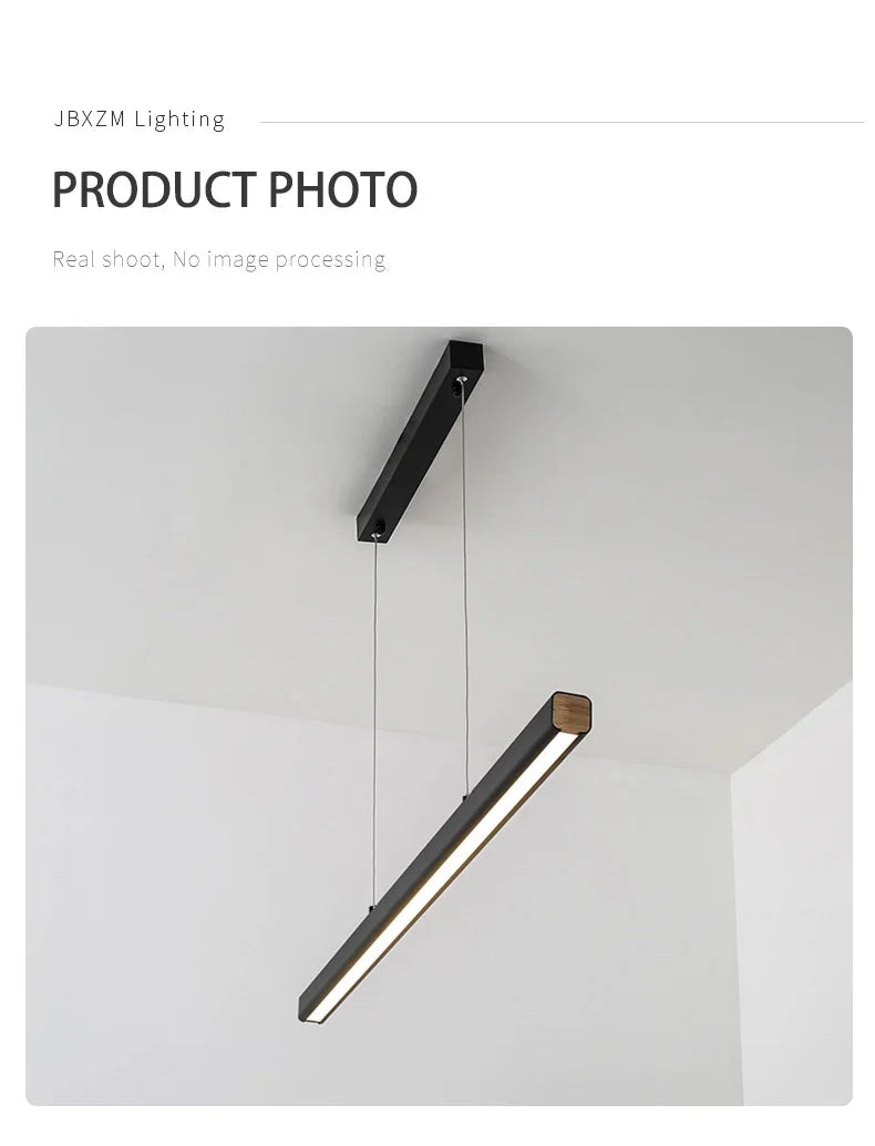 Modern linear LED pendant light suspended above a dining table in a contemporary dining room.