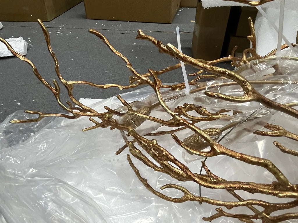 Luxury gold branch crystal chandelier hanging in a modern living room with elegant contemporary décor.