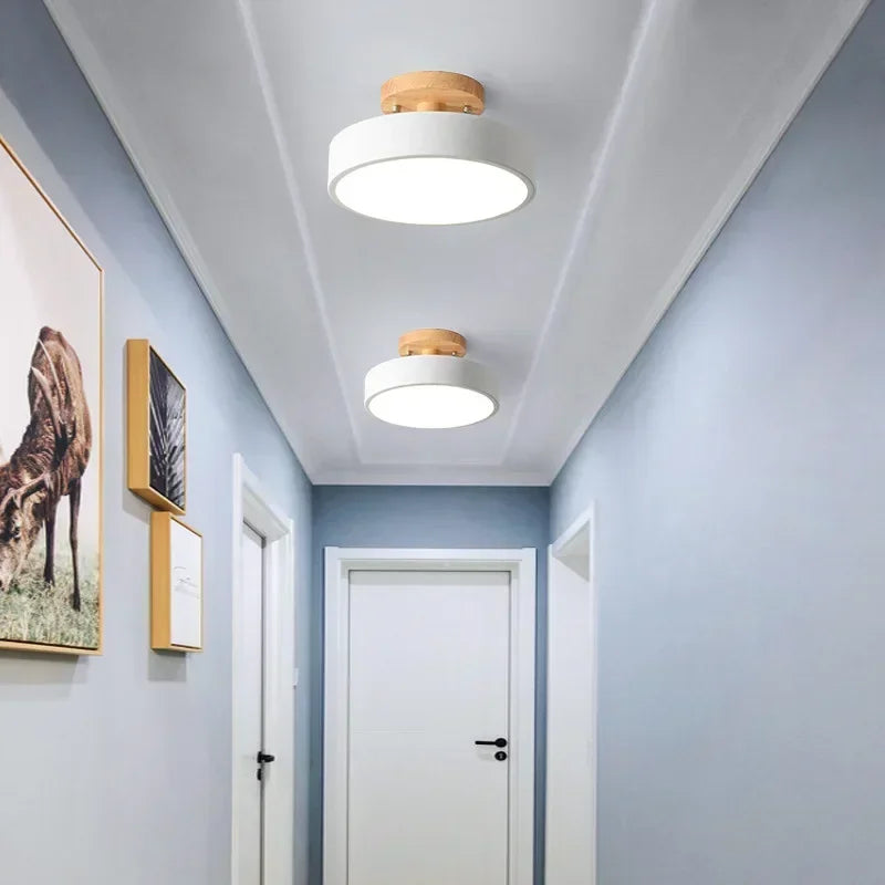 Nordic wood round LED ceiling light installed in a modern hallway with Scandinavian-inspired interior décor.
