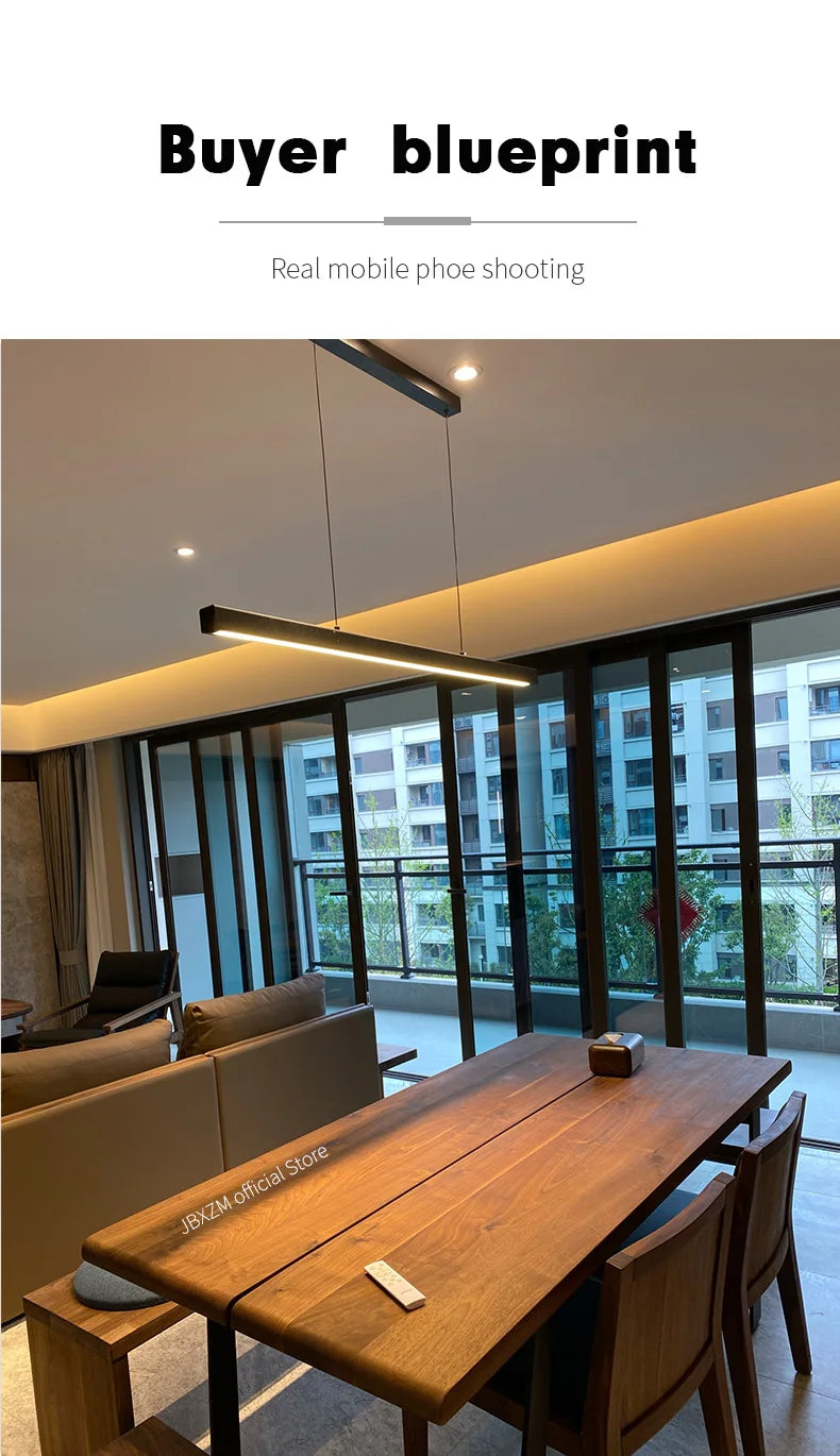 Modern linear LED pendant light suspended above a dining table in a contemporary dining room.