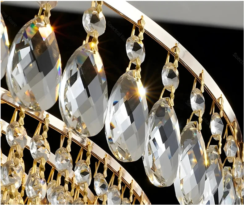 Luxury gold crystal LED chandelier hanging in an elegant modern living room with premium interior décor.