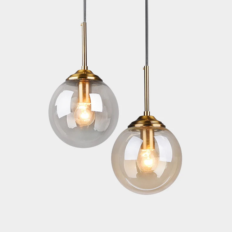 Modern luxury glass LED pendant light hanging above a dining table in a contemporary home.
