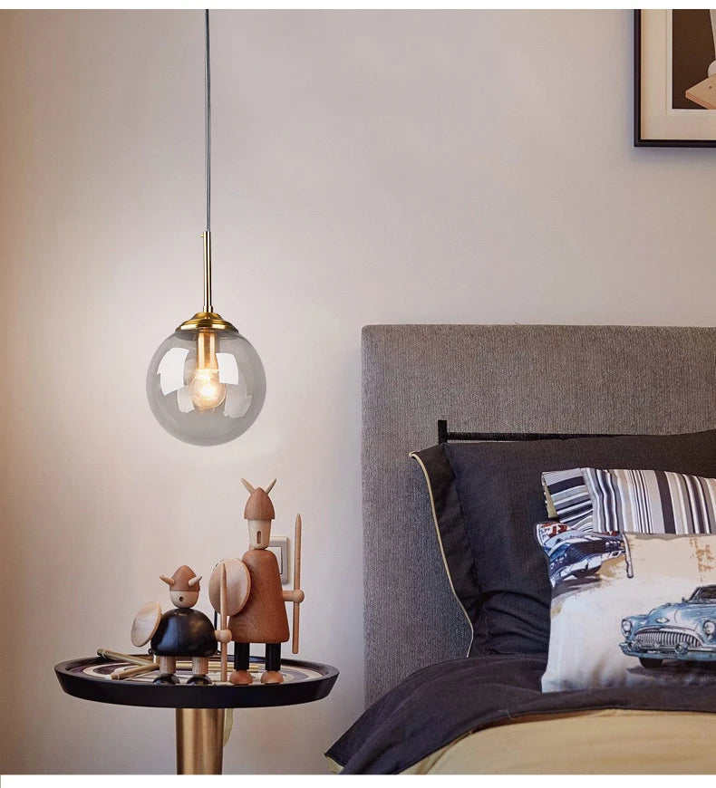 Modern luxury glass LED pendant light hanging above a dining table in a contemporary home.