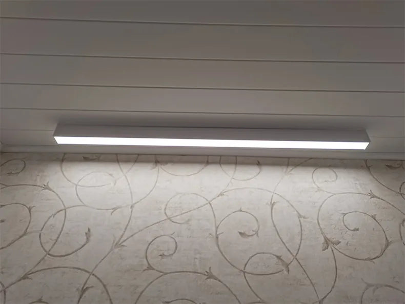 Nordic modern LED ceiling light installed in a contemporary living room with minimalist interior décor.