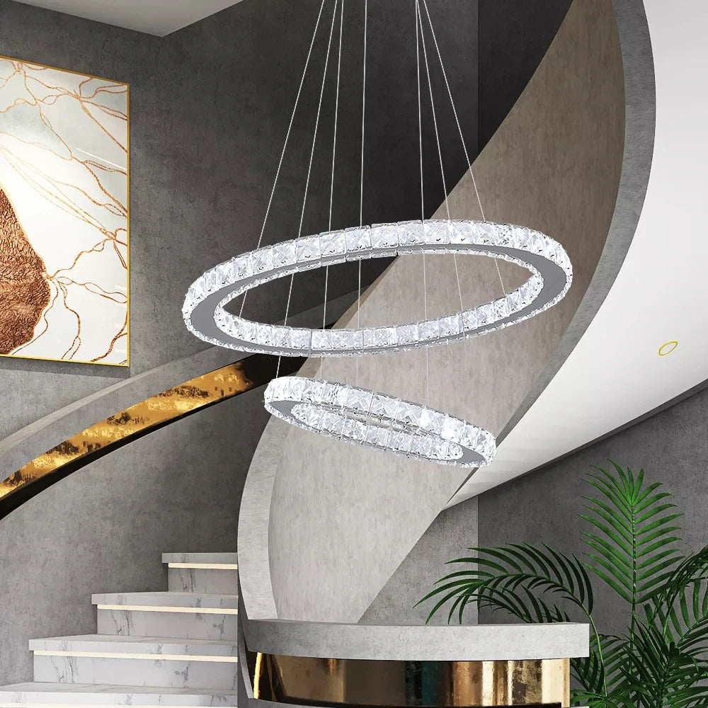 Luxury crystal ring LED chandelier suspended above a modern dining table in an elegant contemporary home.