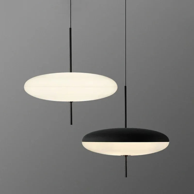 Nordic flying saucer LED pendant light hanging in a modern living room with minimalist décor.