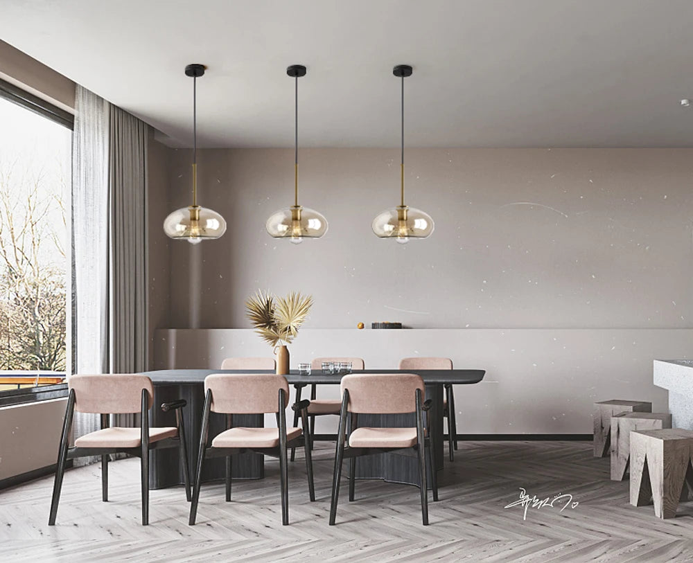 Nordic glass pendant light suspended above a kitchen island in a modern Scandinavian-inspired home.