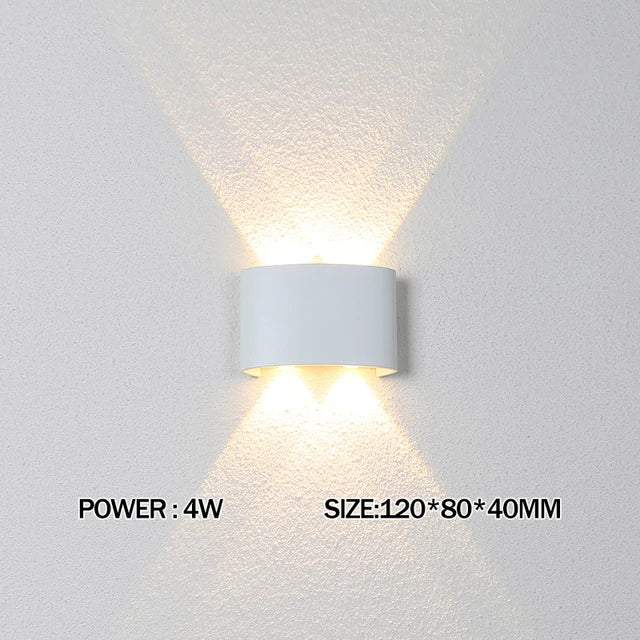 Modern waterproof LED wall light installed on an exterior house wall illuminating a porch and garden.