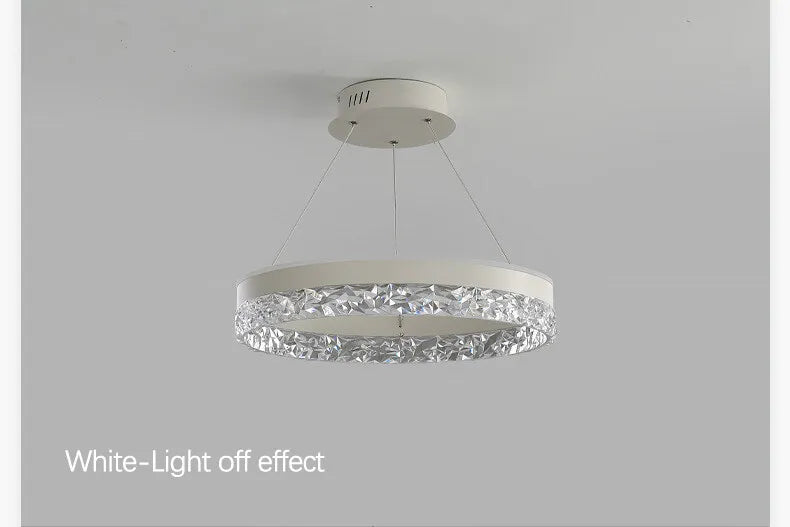 Modern luxe LED ring chandelier suspended in a contemporary living room with elegant minimalist décor.