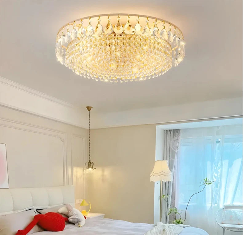 Luxury gold crystal LED chandelier hanging in an elegant modern living room with premium interior décor.