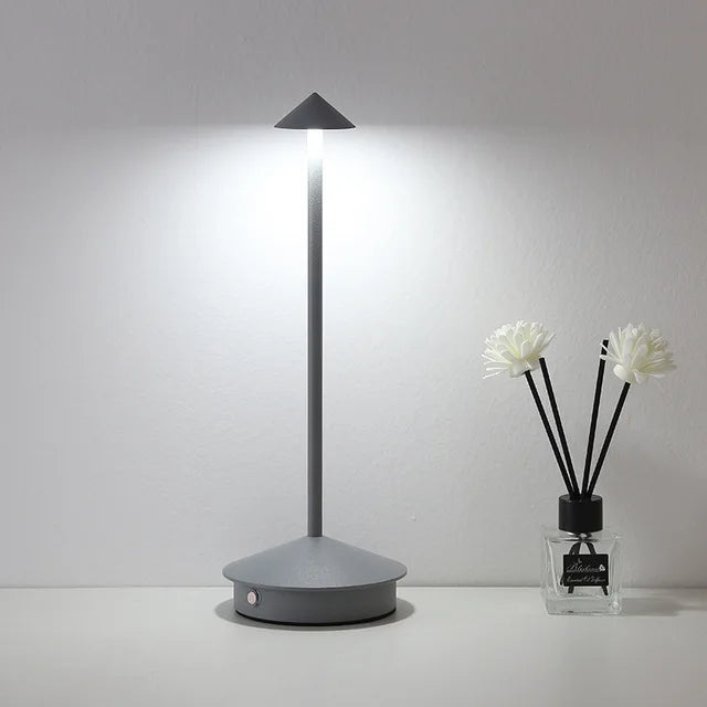 Rechargeable touch LED table lamp placed on a modern dining table in a stylish café-inspired interior.