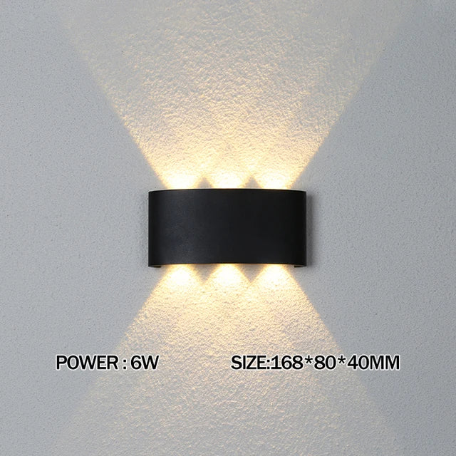 Modern waterproof LED wall light installed on an exterior house wall illuminating a porch and garden.