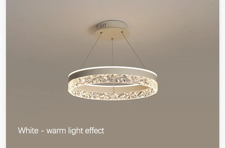 Modern luxe LED ring chandelier suspended in a contemporary living room with elegant minimalist décor.