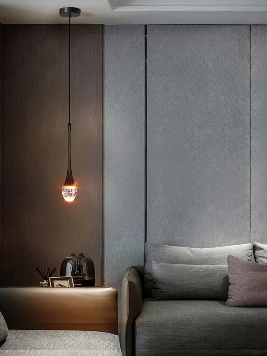 Modern bubble crystal pendant light hanging above a kitchen island in a luxury contemporary home.