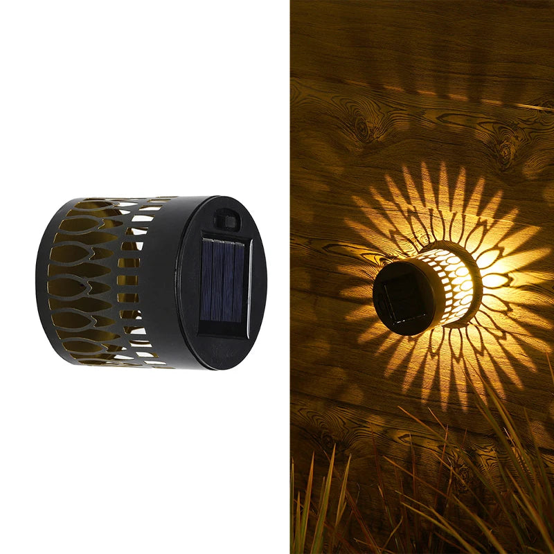 Modern waterproof solar projection LED wall light casting a decorative light pattern on an outdoor garden wall.