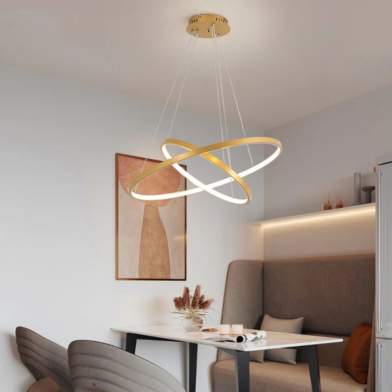 Modern LED ring chandelier suspended above a dining table in a luxury contemporary home.