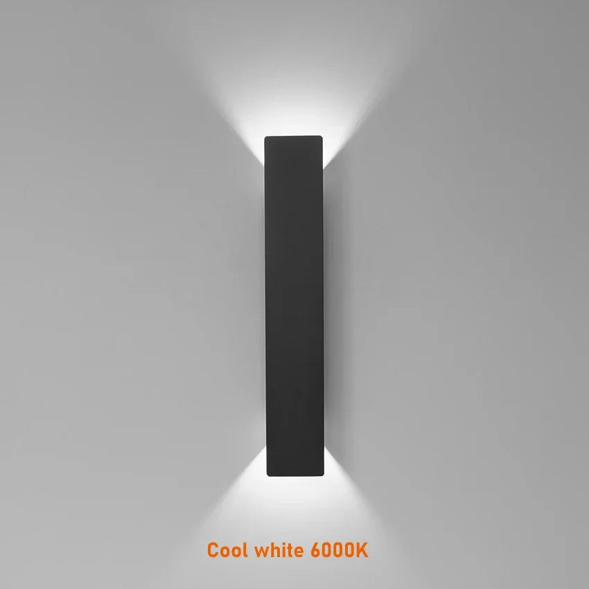 Modern black aluminum IP65 waterproof LED wall light mounted on an exterior wall with an up-and-down lighting effect.