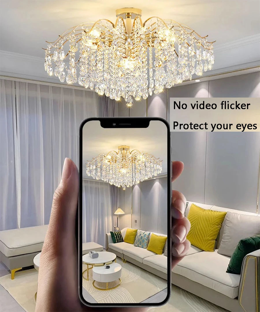 Modern luxury crystal LED chandelier installed in a stylish living room with elegant contemporary décor.
