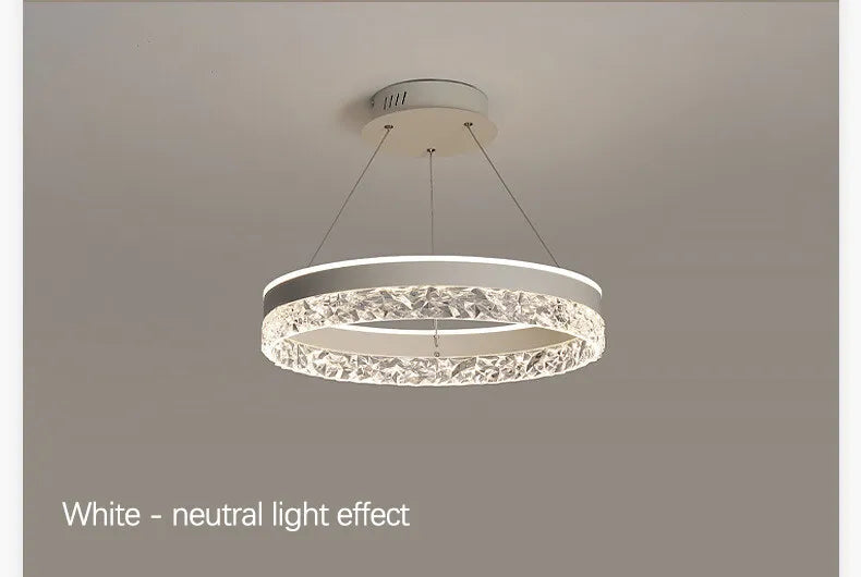 Modern luxe LED ring chandelier suspended in a contemporary living room with elegant minimalist décor.