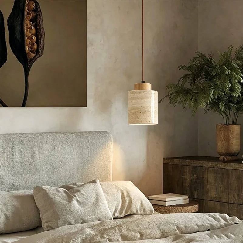 Wabi-Sabi Japanese pendant light with a natural stone-inspired shade hanging beside a modern bed.