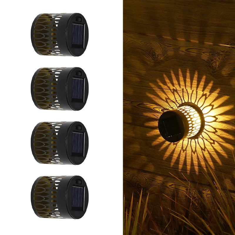 Modern waterproof solar projection LED wall light casting a decorative light pattern on an outdoor garden wall.