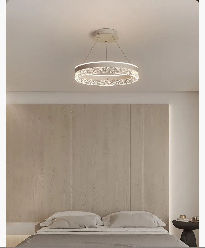 Modern luxe LED ring chandelier suspended in a contemporary living room with elegant minimalist décor.