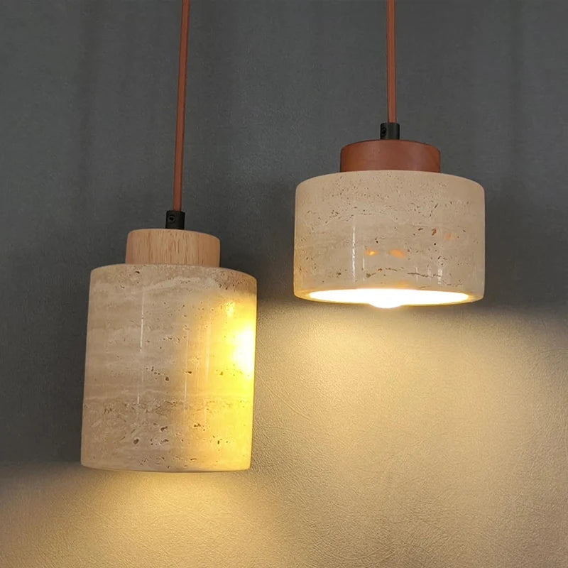 Wabi-Sabi Japanese pendant light with a natural stone-inspired shade hanging beside a modern bed.