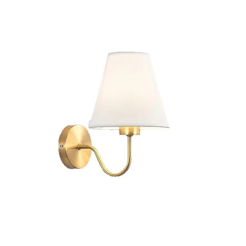 Modern fabric wall sconce installed beside a bed in a contemporary bedroom with warm ambient lighting.