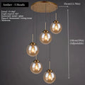 Luxury Nordic glass LED pendant light hanging above a modern dining table in a contemporary home.