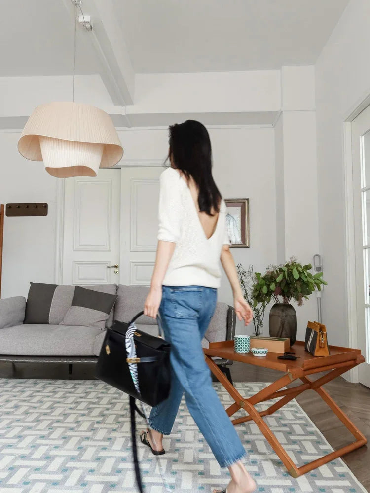 Nordic modern LED pendant light hanging above a dining table in a contemporary living room.