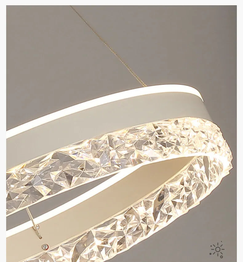 Modern luxe LED ring chandelier suspended in a contemporary living room with elegant minimalist décor.