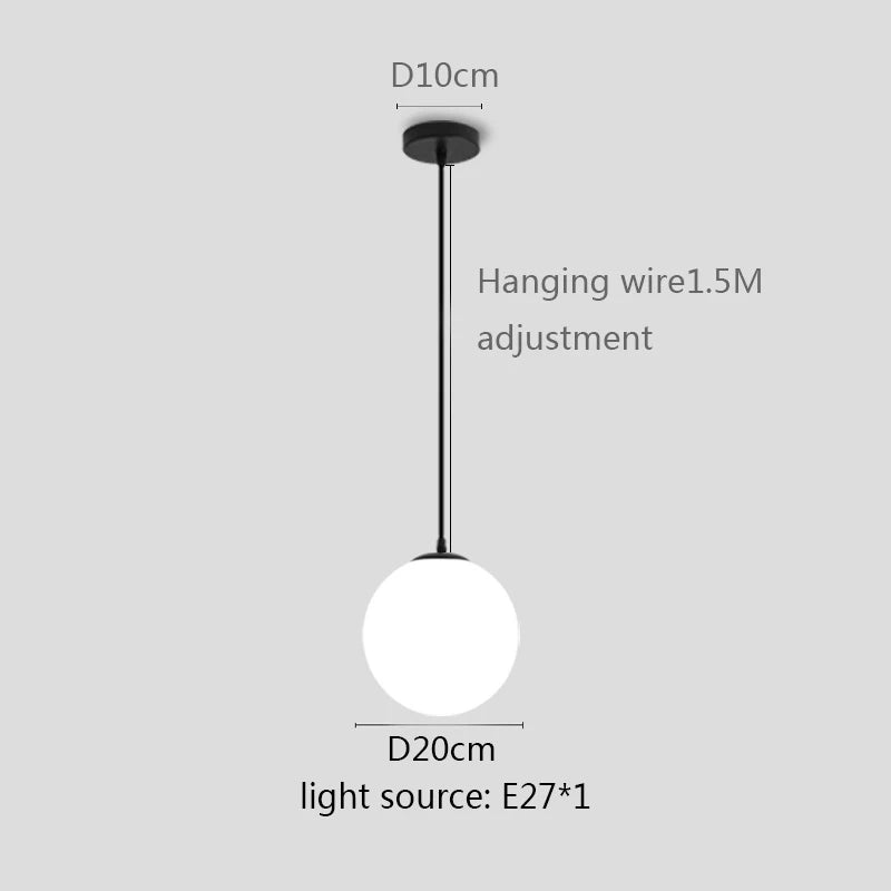 Modern glass globe pendant light with gold finish hanging above a contemporary dining table.