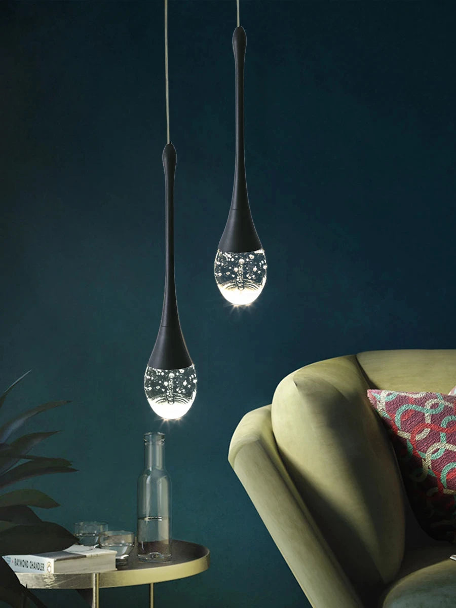 Modern bubble crystal pendant light hanging above a kitchen island in a luxury contemporary home.